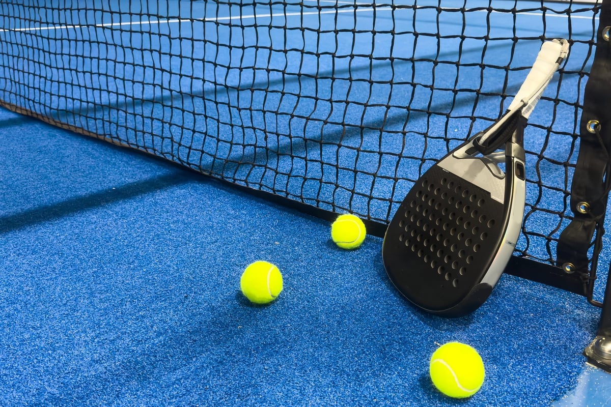 Padel racket, ball, and court at Padel 956